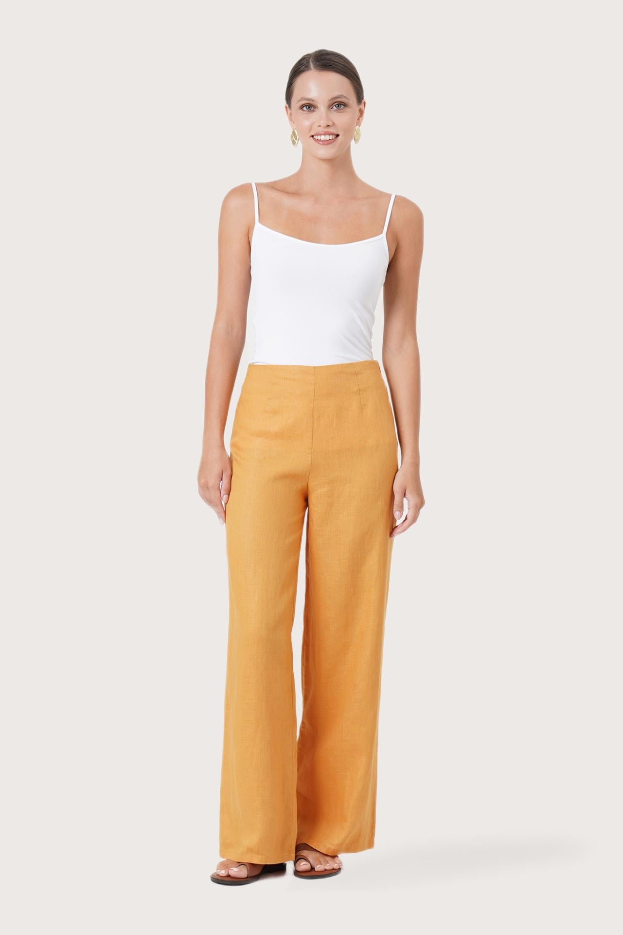 Woman wearing the Kerang Women's Linen Pants Orange designed for effortless resortwear and tropical living by By The Sea Bali.