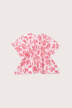 Child wearing the pink white cotton Kids Kaftan by By The Sea Bali