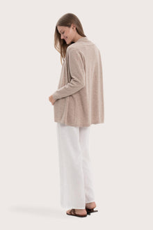 Back view of the beige cashmere outerwear with a relaxed and elegant silhouette