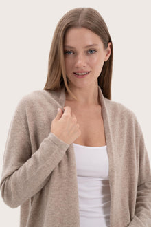 Close-up of the cashmere texture and premium detailing on the beige outerwear