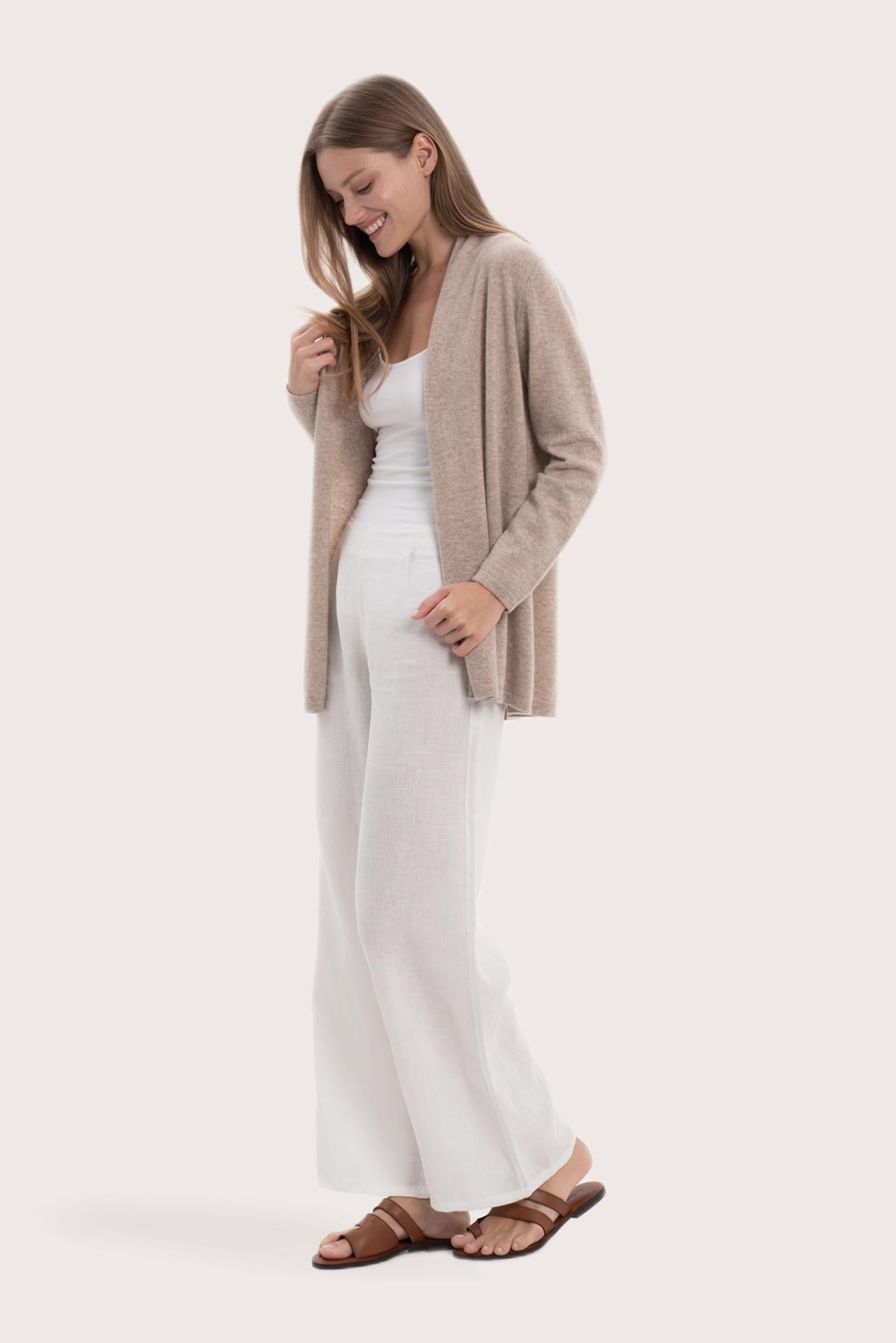 Side profile of the beige cashmere outerwear showcasing its soft drape and refined fit