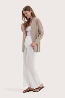 Side profile of the beige cashmere outerwear showcasing its soft drape and refined fit