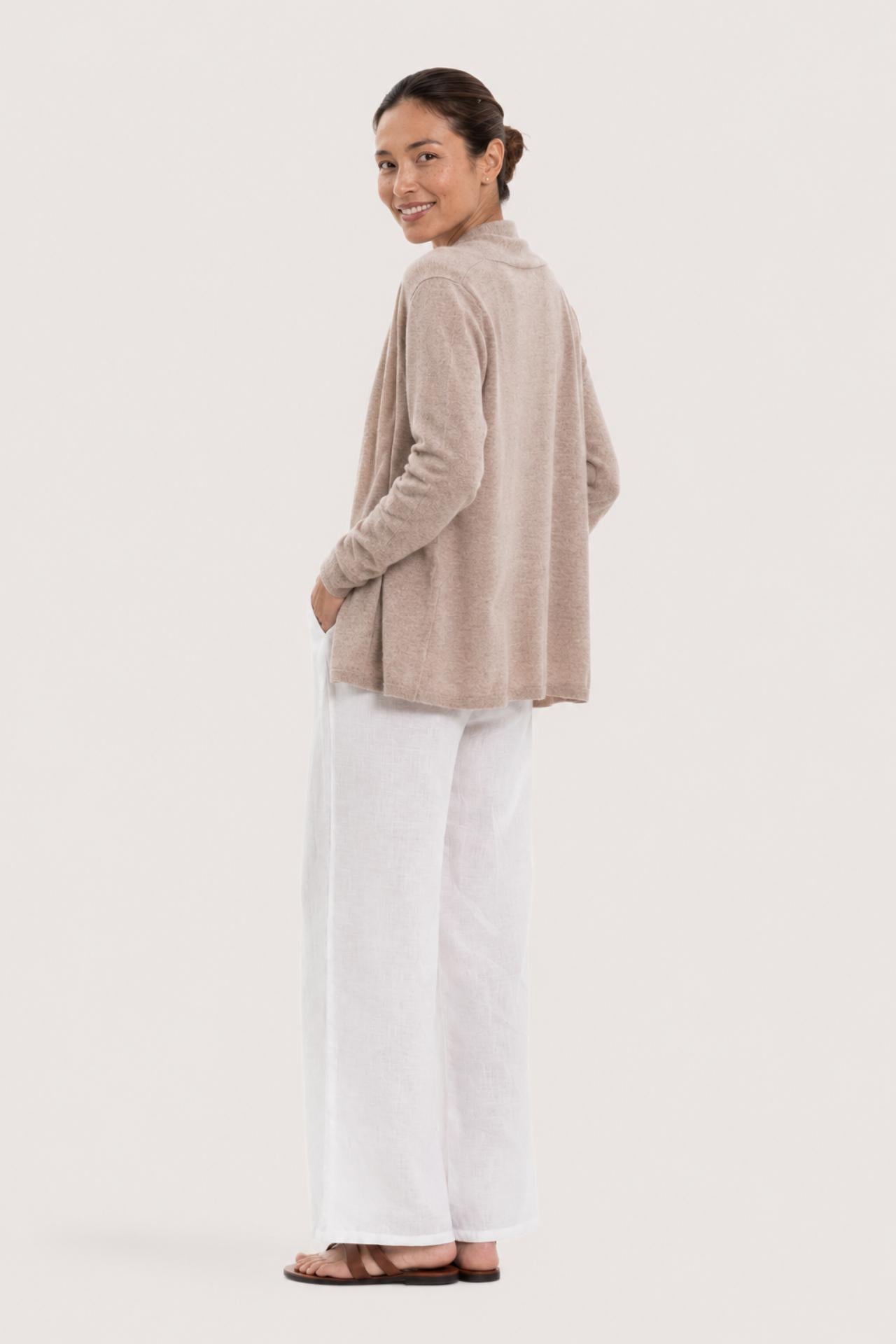 Back view of a woman wearing the beige cashmere Klarr outerwear