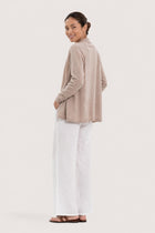 Back view of a woman wearing the beige cashmere Klarr outerwear