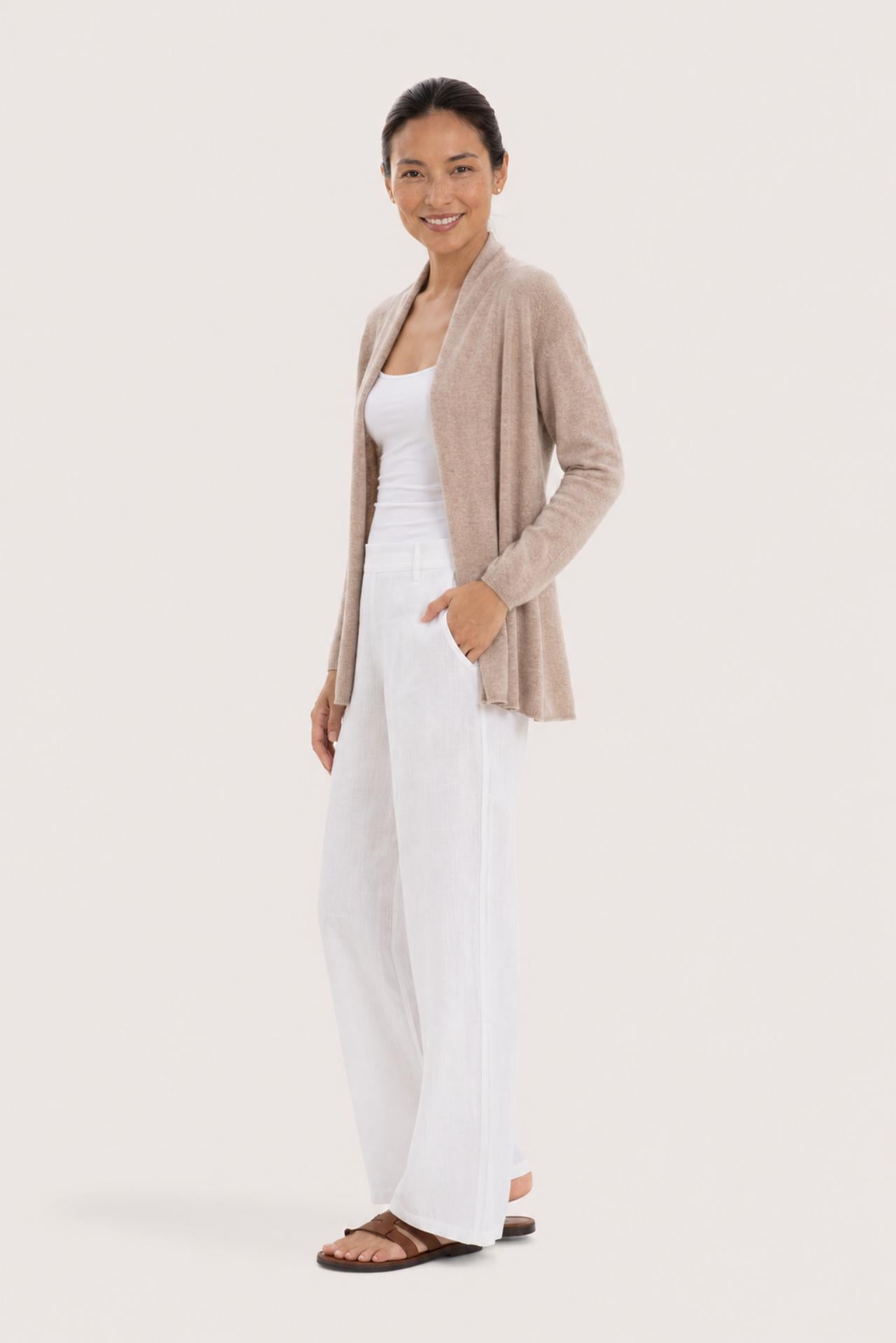 Side profile of a woman wearing the beige cashmere Klarr outerwear