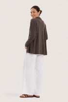 Back view of a woman wearing the brown cashmere Klarr outerwear