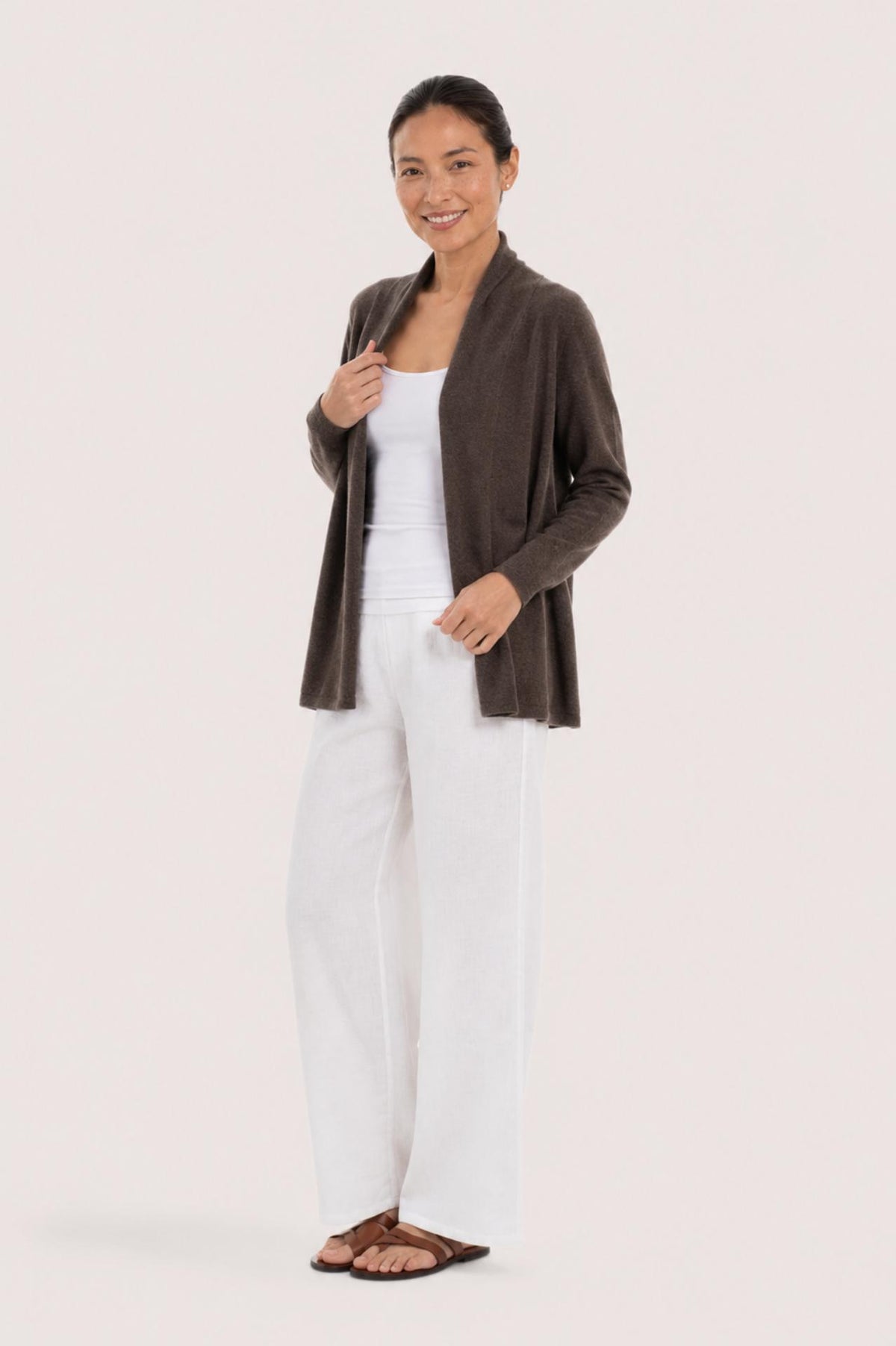 Side profile of a woman wearing the brown cashmere Klarr outerwear