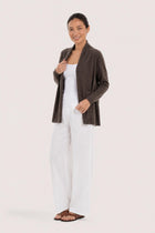 Side profile of a woman wearing the brown cashmere Klarr outerwear