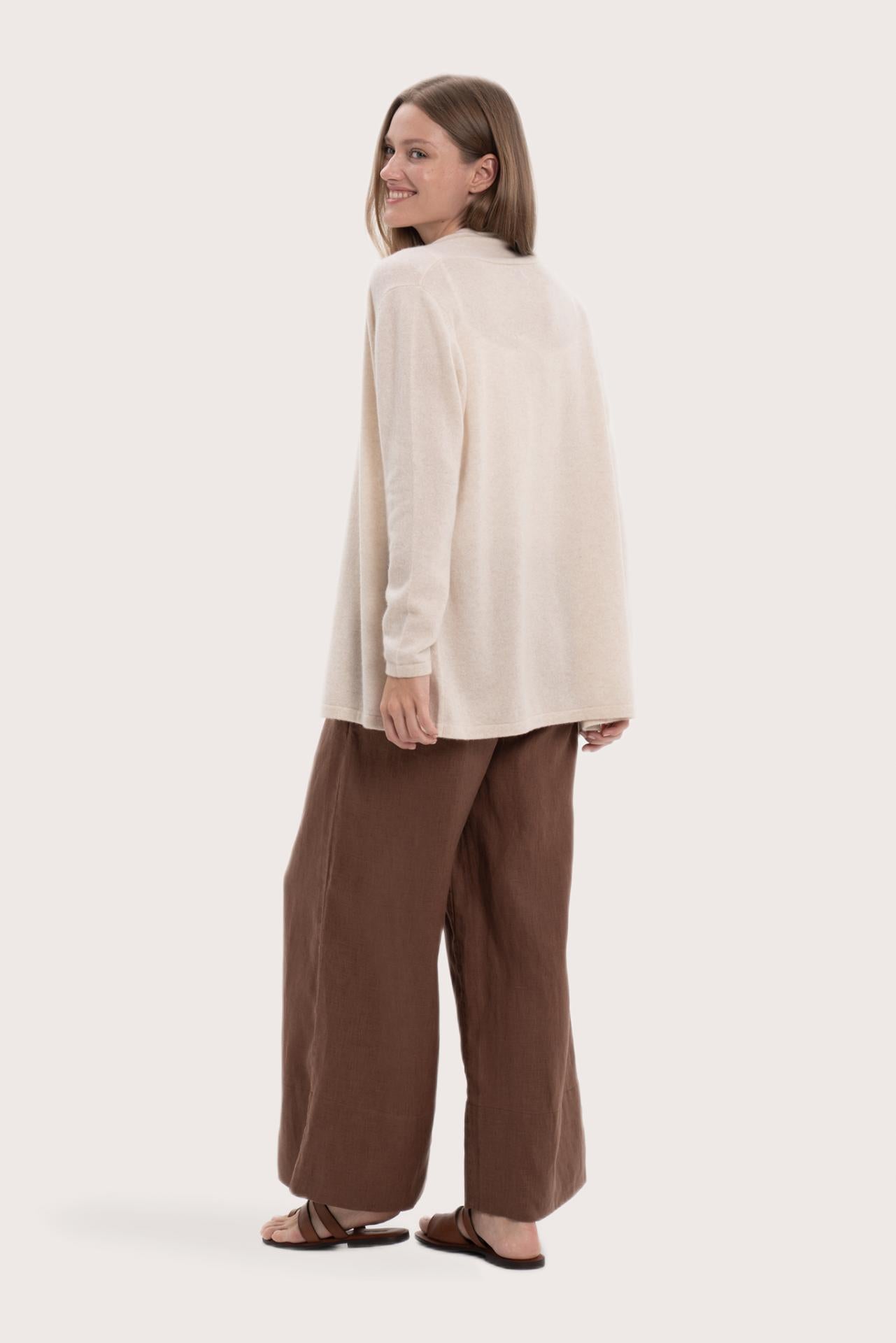 Back view of the natural cashmere outerwear with a relaxed and elegant silhouette