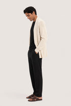 Side profile of a man wearing the natural cashmere Klarr outerwear