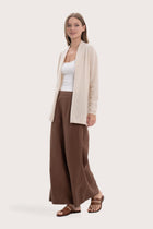 Side profile of the natural cashmere outerwear showcasing its soft drape and refined fit