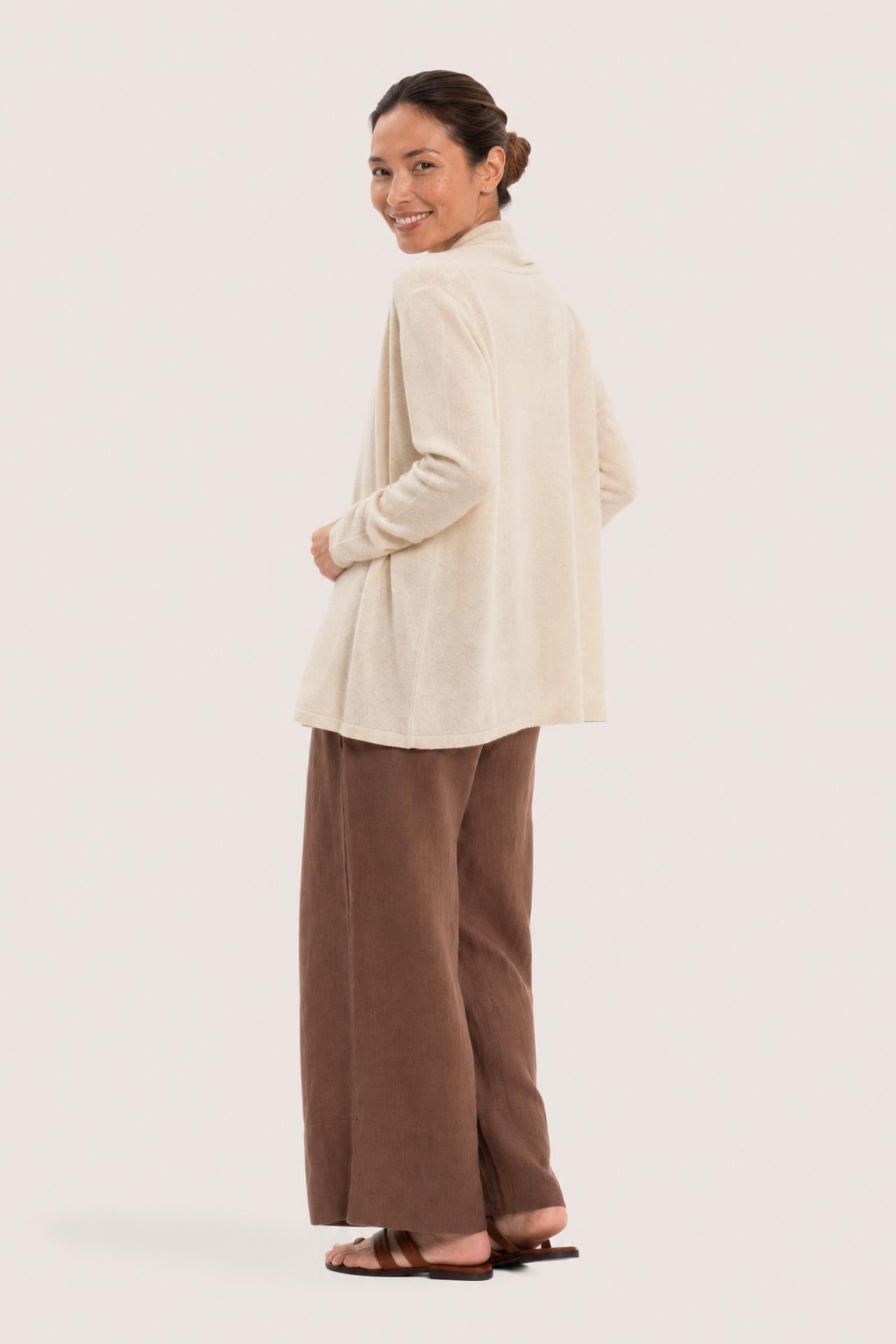 Back view of a woman wearing the natural cashmere Klarr outerwear