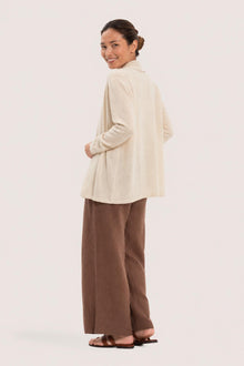 Back view of a woman wearing the natural cashmere Klarr outerwear