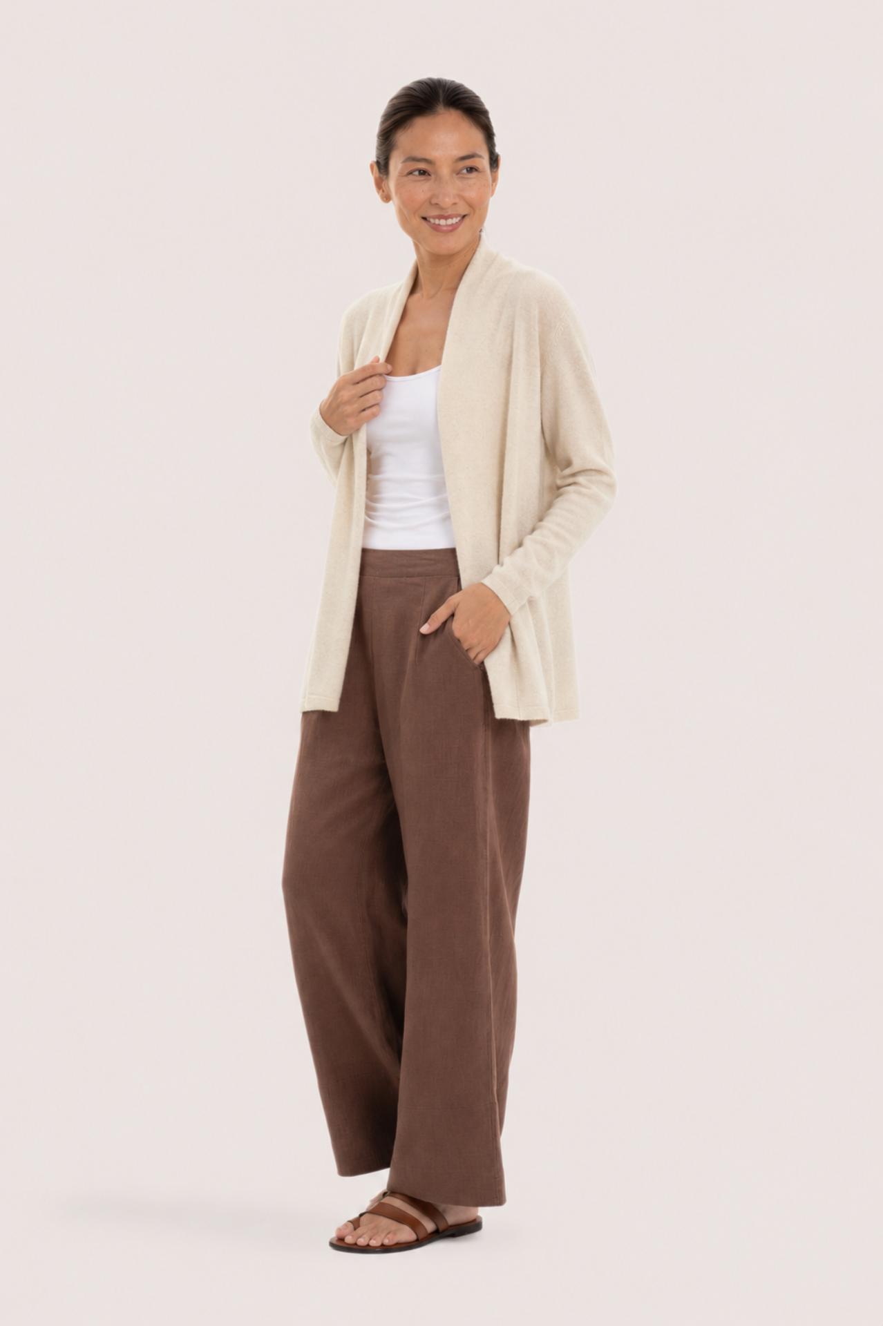 Side profile of a woman wearing the natural cashmere Klarr outerwear