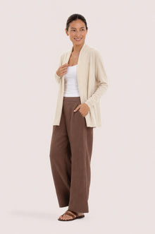 Side profile of a woman wearing the natural cashmere Klarr outerwear
