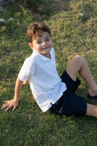 Relaxed resort styling featuring the Koda Boys Cotton Bermuda in Navy