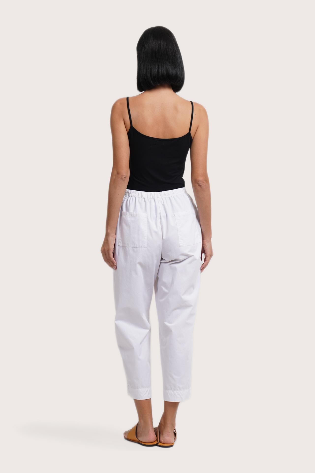 Back view of the Ladies Cropped Cotton Pants White highlighting the garment shape and drape