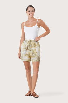 Woman wearing the Laica Linen Short The Island Multicolor White Base  designed for effortless resortwear and tropical living by By The Sea Bali