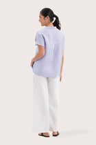 Back view of the Laluna linen Shirt Lavender highlighting the garment shape and drape.
