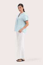 Side profile of the Laluna linen Shirt Light Green showing its cut and natural movement.