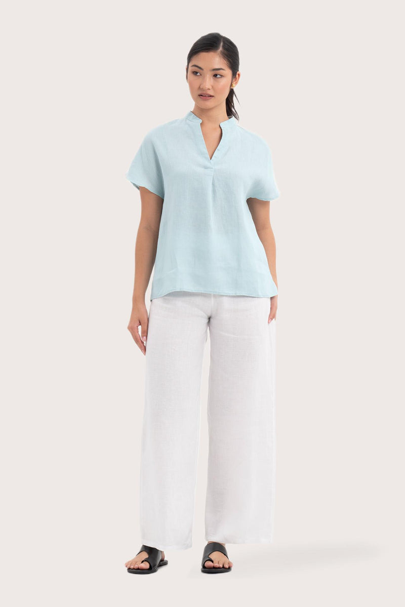 Woman wearing the Laluna linen Shirt  Light Green designed for effortless resortwear and tropical living by By The Sea Bali.