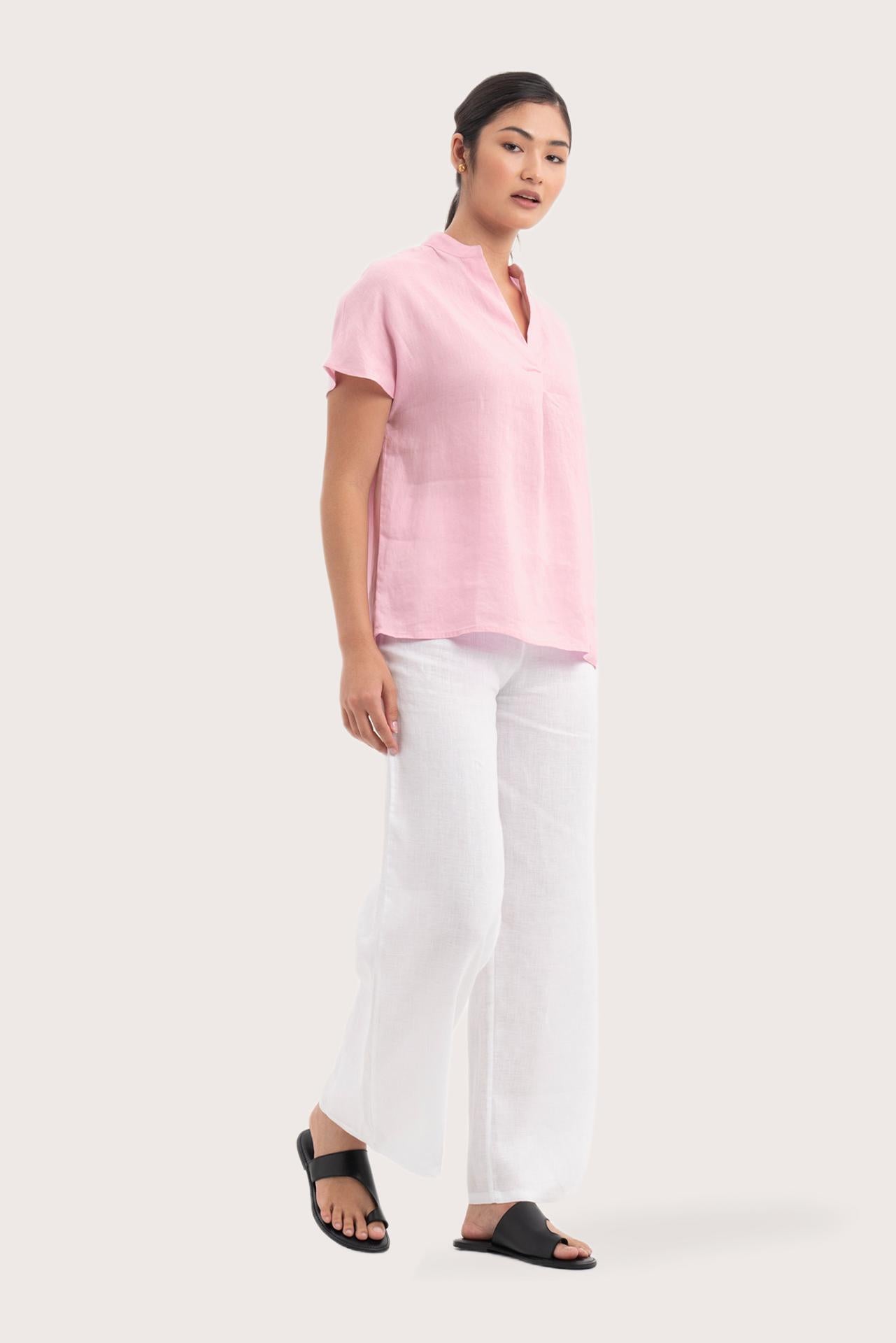 Side profile of the Laluna linen Shirt Light Pink showing its cut and natural movement.