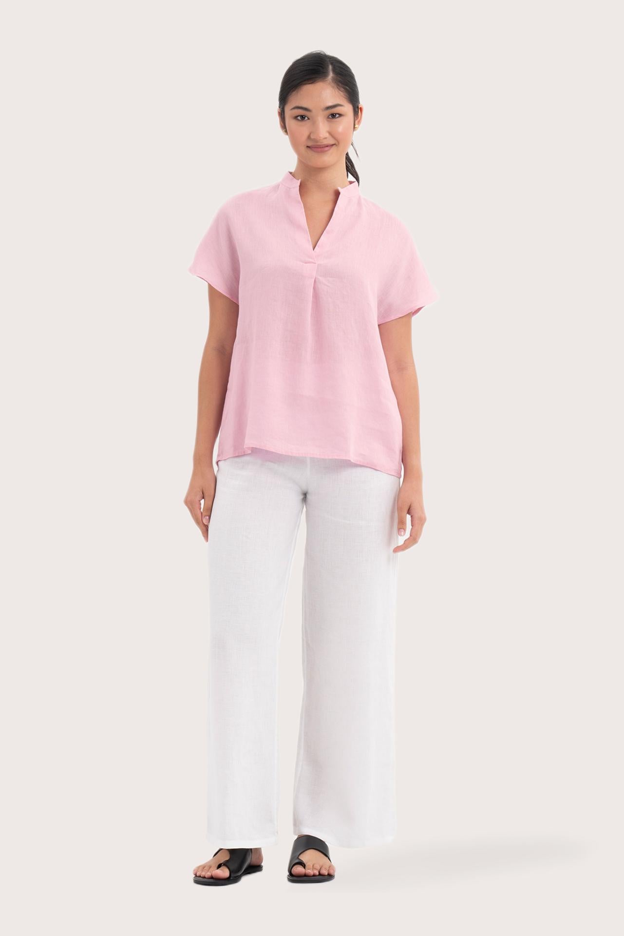 Woman wearing the Laluna linen Shirt  Light Pink designed for effortless resortwear and tropical living by By The Sea Bali.