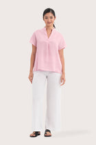 Woman wearing the Laluna linen Shirt  Light Pink designed for effortless resortwear and tropical living by By The Sea Bali.