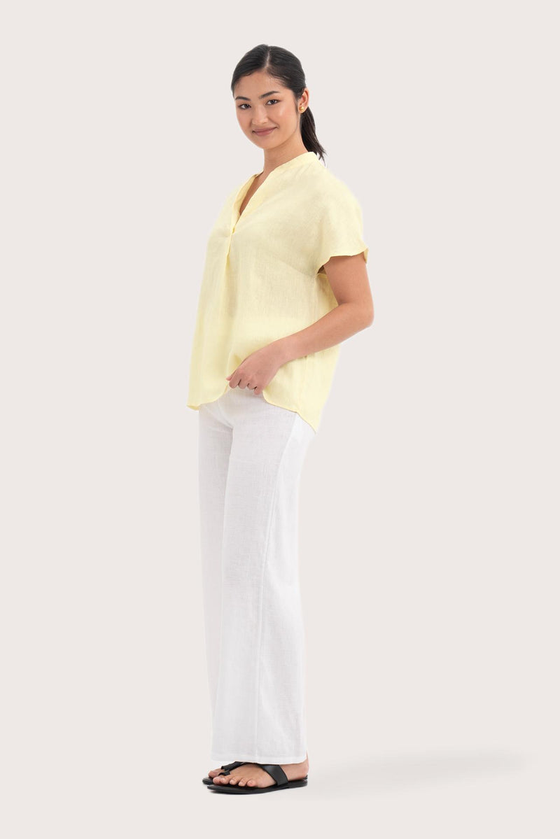 Side profile of the Laluna linen Shirt Light Yellow showing its cut and natural movement.