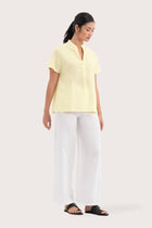 Side profile of the Laluna linen Shirt Light Yellow showing its cut and natural movement.