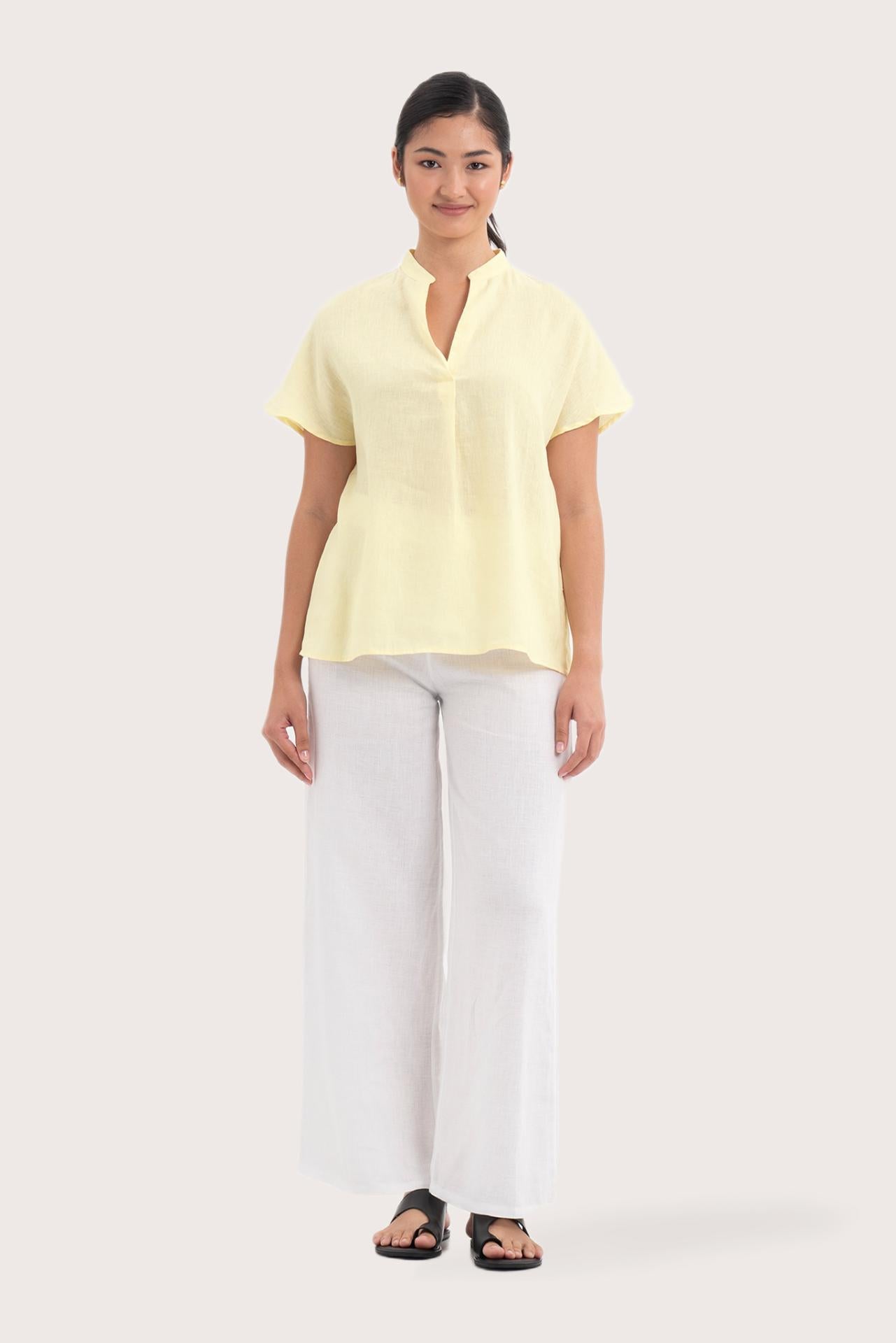 Woman wearing the Laluna linen Shirt  Light Yellow designed for effortless resortwear and tropical living by By The Sea Bali.