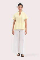 Woman wearing the Laluna linen Shirt  Light Yellow designed for effortless resortwear and tropical living by By The Sea Bali.
