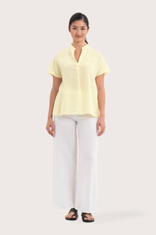 Woman wearing the Laluna linen Shirt  Light Yellow designed for effortless resortwear and tropical living by By The Sea Bali.