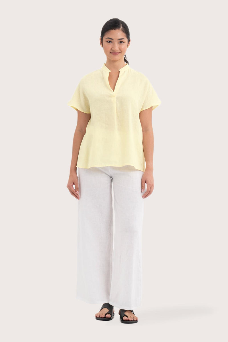 Woman wearing the Laluna linen Shirt  Light Yellow designed for effortless resortwear and tropical living by By The Sea Bali.