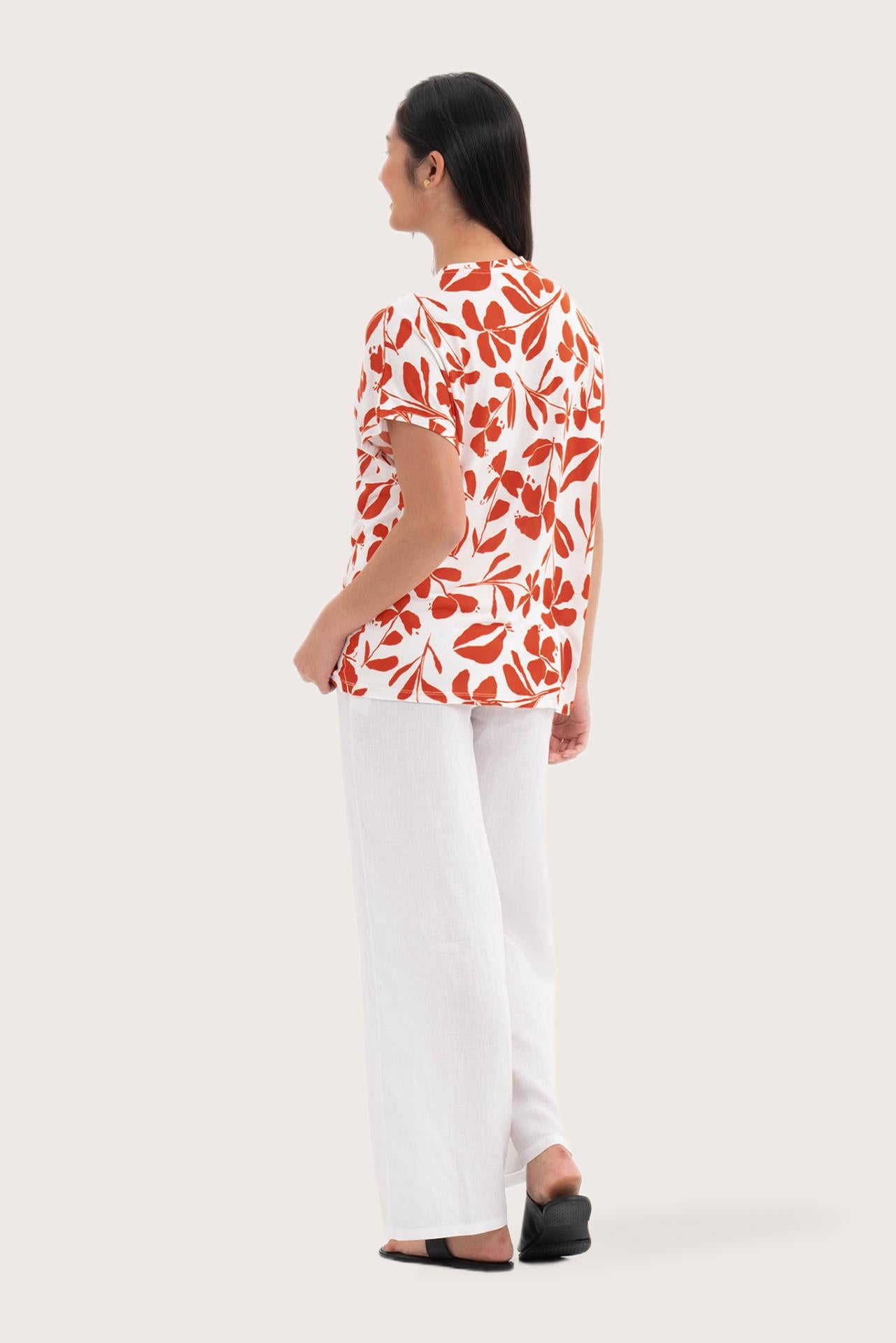 Back view of the Lenore Printed Top Flower Dark Orange highlighting the garment shape and drape.