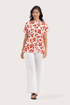 Woman wearing the Lenore Printed Top Flower Dark Orange designed for effortless resortwear and tropical living, by By The Sea Bali.