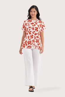 Woman wearing the Lenore Printed Top Flower Dark Orange designed for effortless resortwear and tropical living, by By The Sea Bali.