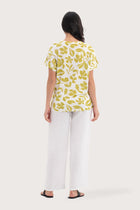 Back view of the Lenore Printed Top Flower Green highlighting the garment shape and drape.