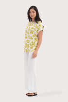 Side profile of the Lenore Printed Top Flower Green showing its cut and natural movement.
