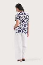 Back view of the Lenore Printed Top Flower Purple highlighting the garment shape and drape.