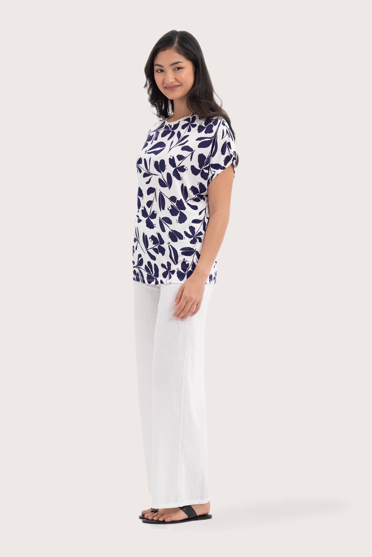 Side profile of the Lenore Printed Top Flower Purple showing its cut and natural movement.