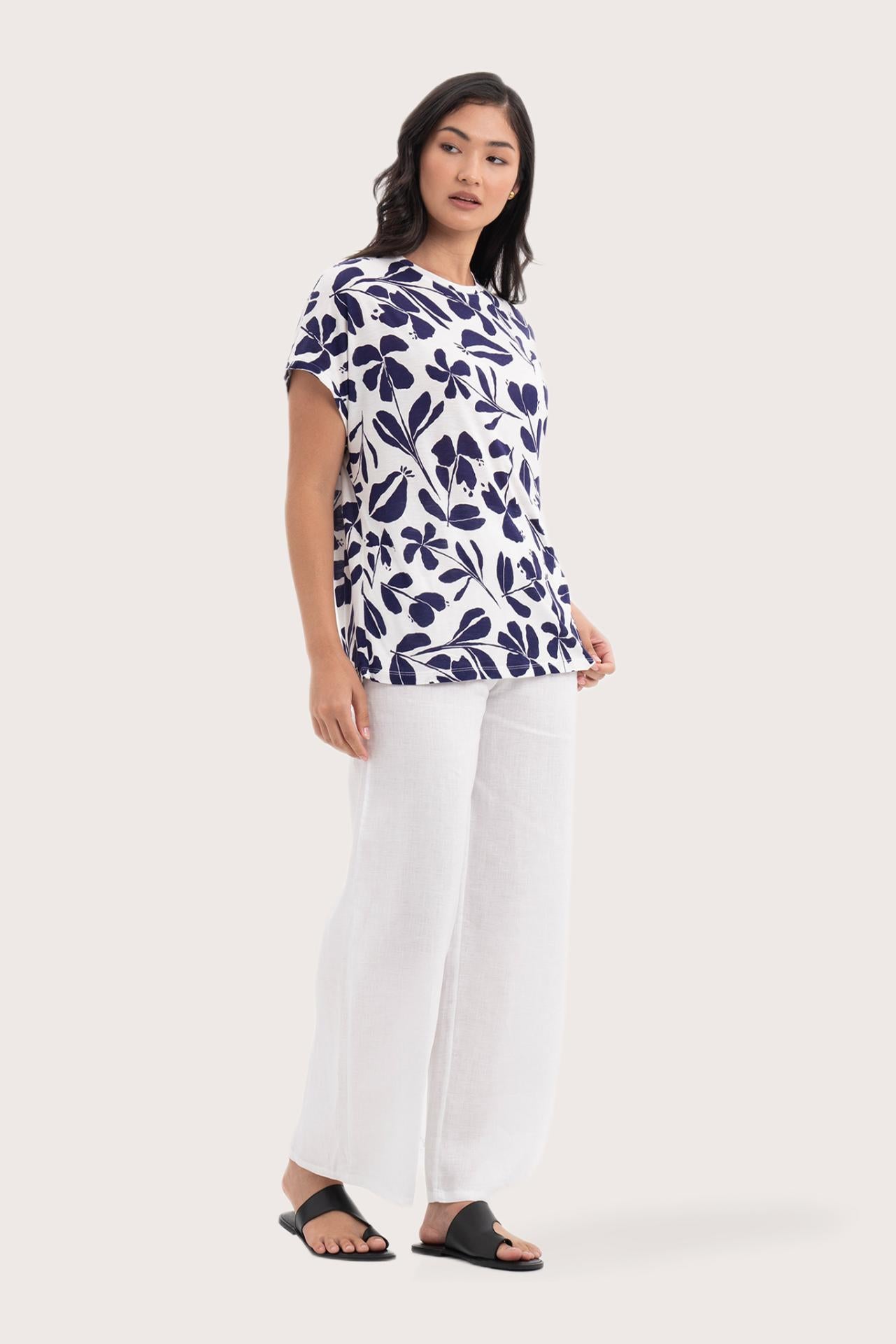 Side profile of the Lenore Printed Top Flower Purple showing its cut and natural movement.