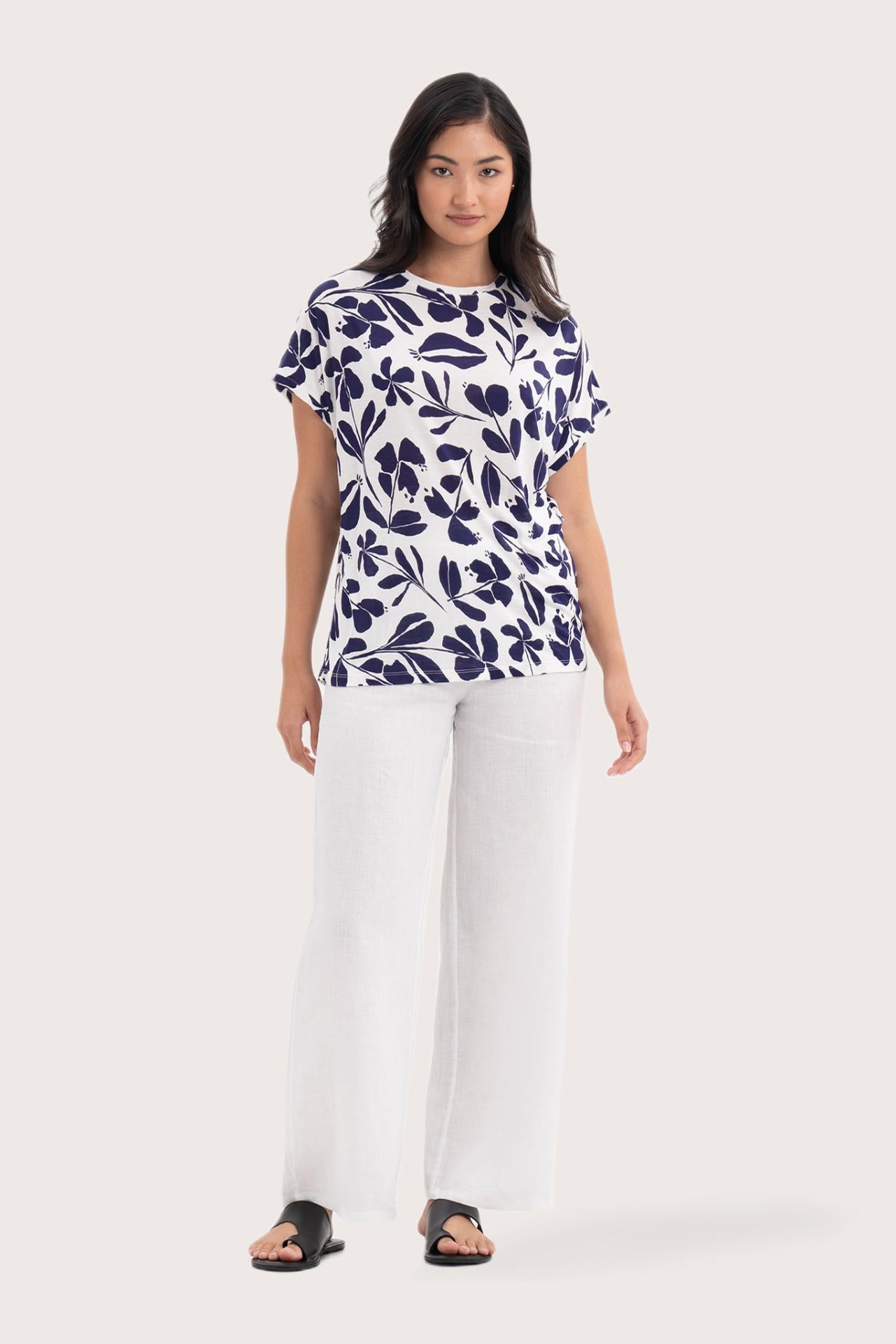 Woman wearing the Lenore Printed Top Flower Purple designed for effortless resortwear and tropical living, by By The Sea Bali.