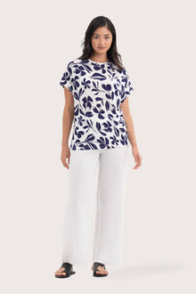 Woman wearing the Lenore Printed Top Flower Purple designed for effortless resortwear and tropical living, by By The Sea Bali.