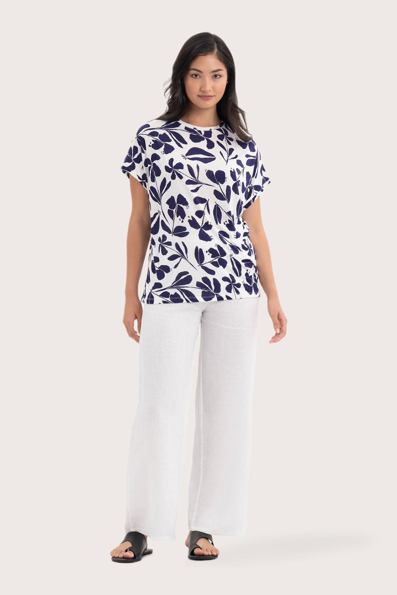 Woman wearing the Lenore Printed Top Flower Purple designed for effortless resortwear and tropical living, by By The Sea Bali.