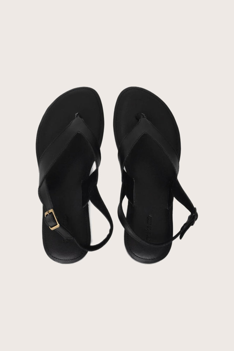Levi sandal in black shown in a global view highlighting its full silhouette and refined resort design