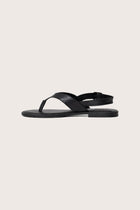 Side profile of Levi sandal in black highlighting modern, streamlined resort footwear silhouette