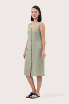 Side profile of the Linda Front Button Midi Linen Dress Sage showing its cut and natural movement