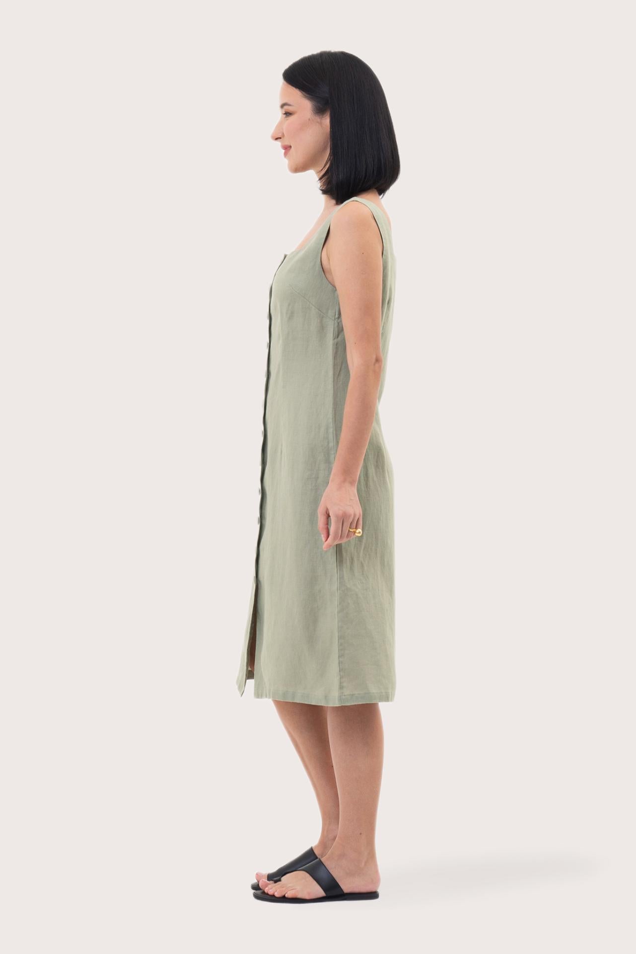 Side profile of the Linda Front Button Midi Linen Dress Sage showing its cut and natural movement