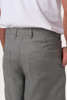 Detailed back view highlighting the relaxed silhouette and linen craftsmanship
